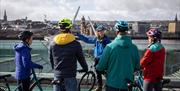 Group overlooking the Peace Bridge in Derry city on the Foodie Cycle Tour