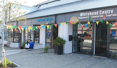 Photograph of Whitehead Centre on opening day. Coloured bunting is across the front of the building. 