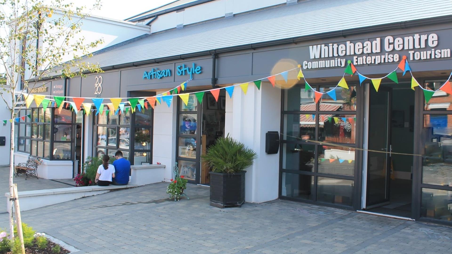 Photograph of Whitehead Centre on opening day. Coloured bunting is across the front of the building.