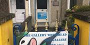 Entrance door with The Gallery Whitehead sign on the gate