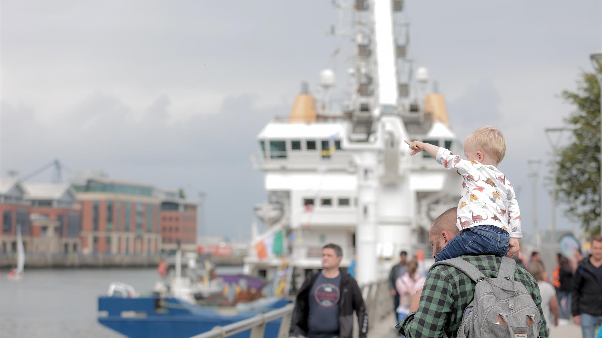 Crowds gather along Queens Quay in Belfast to enjoy Belfast Maritime Festival.