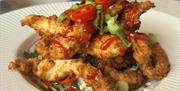 The Stables Groomsport image of plated Honey Chilli Chicken a delicious and spicy dish that combines sweet and tangy flavors. It pairs perfectly with