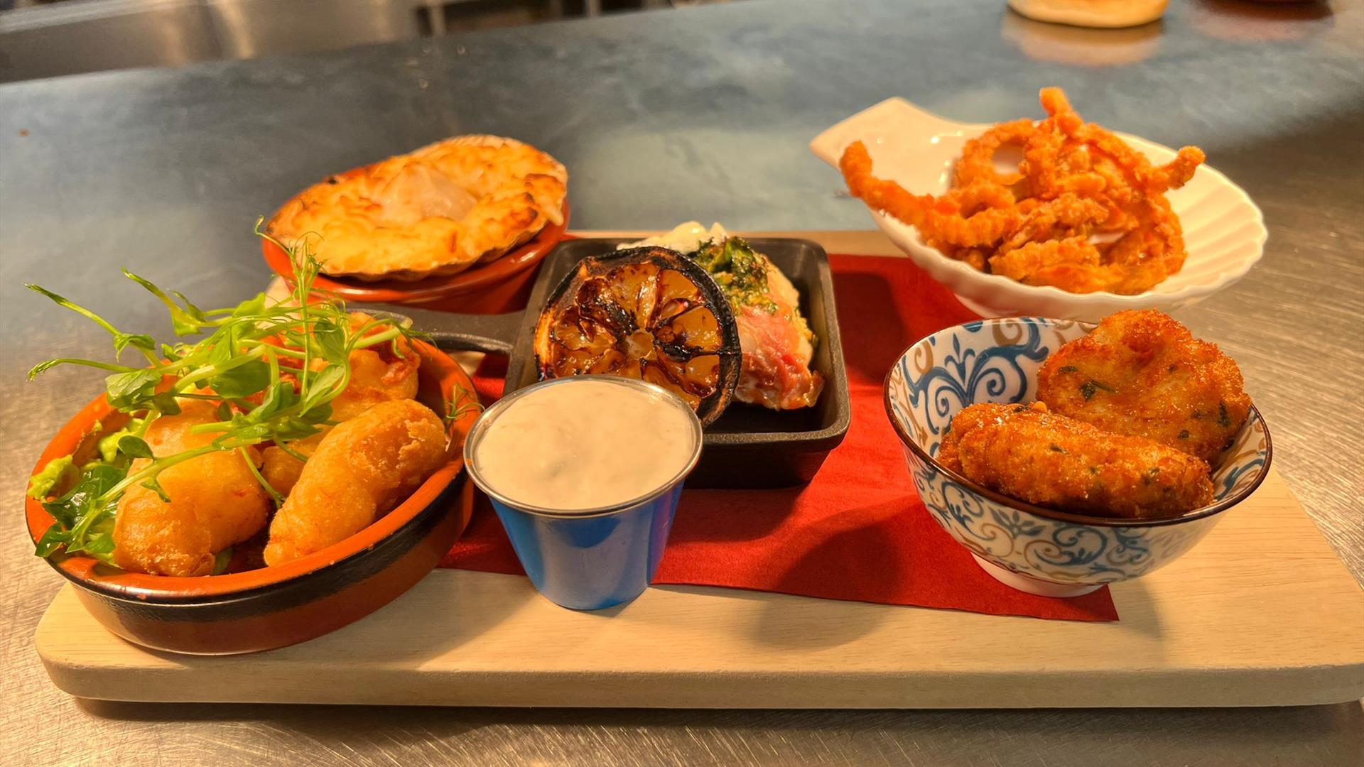 An image of a selection of food on a serving board that can be ordered at the Speckled hen