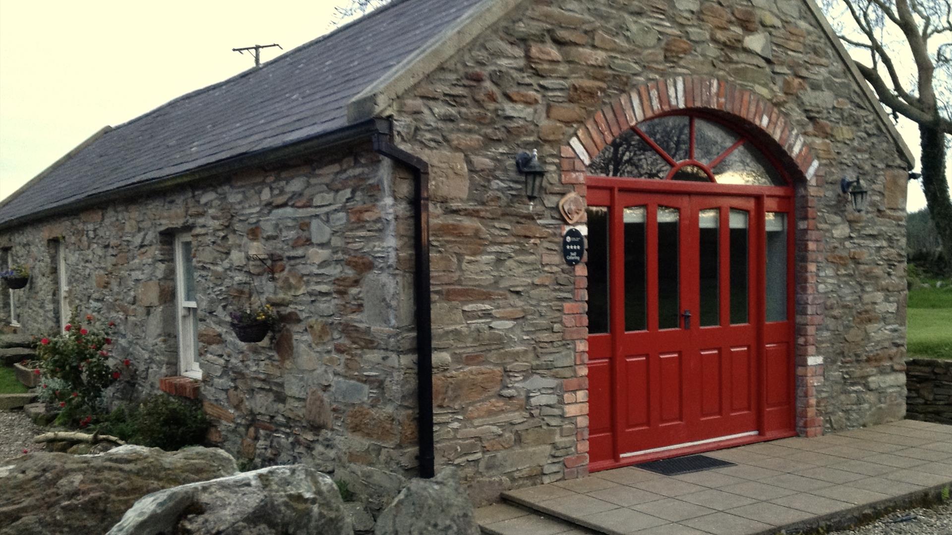 Mill Cottage showing red double doors