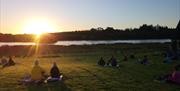 Group enjoying sunrise yoga on Devenish Island
