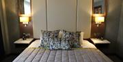 Double bed with bedside lockers and lamps