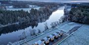 Snowy aerial image of the lodges and the river Bann