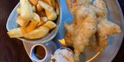 Fish and chips with tartar sauce served on a plate