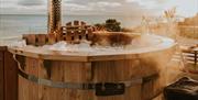 Luxury 4 person Scandinavian wood burning hot tub with a built in jet system and mood lightening. 

