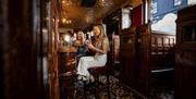 Two girls sitting at bar at McConville's Bar Portadown