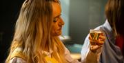 Girl tasting a sample of beer during the Beer Masterclass at the Walled City Brewery in Derry~Londonderry
