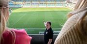 Guide doing a tour and showing the group the pitch as part of a guided tour at Windsor Par with the Irish Football Association