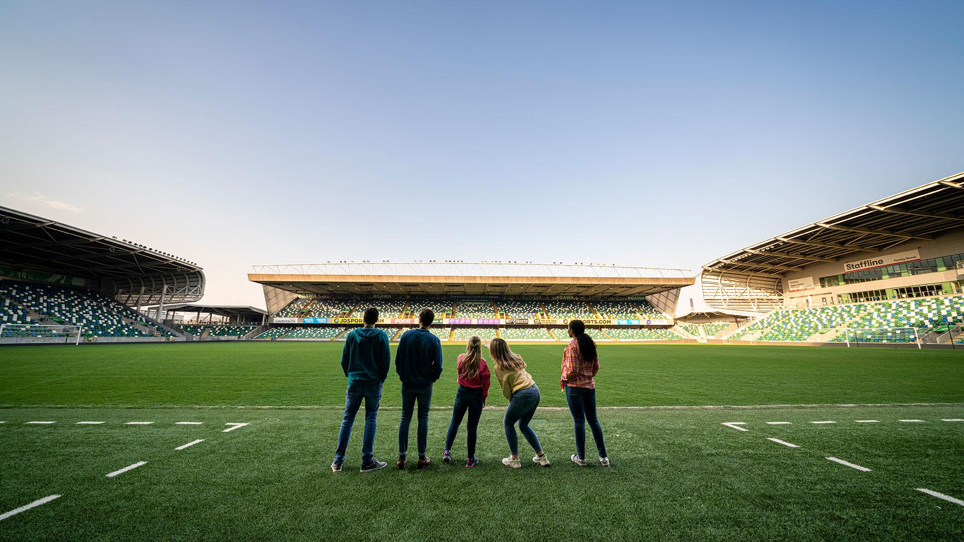 Group standing on the pitch as part of a behind the scenes guided tour of Windsor Park with the Irish Football Association