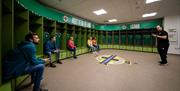 Group in the player's changing rooms as part of a behind the scenes guided tour of Windsor Park with the Irish Football Association