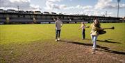 People practicising their hurl swing on the pitch at Armagh GAA