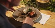 A guest tucks into a delicious plate of locally sourced ingredients