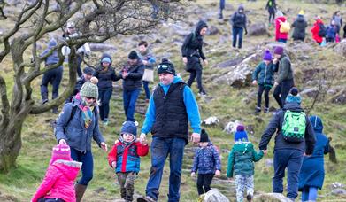 Crowds of people climbing Slemish on St Patricks Day