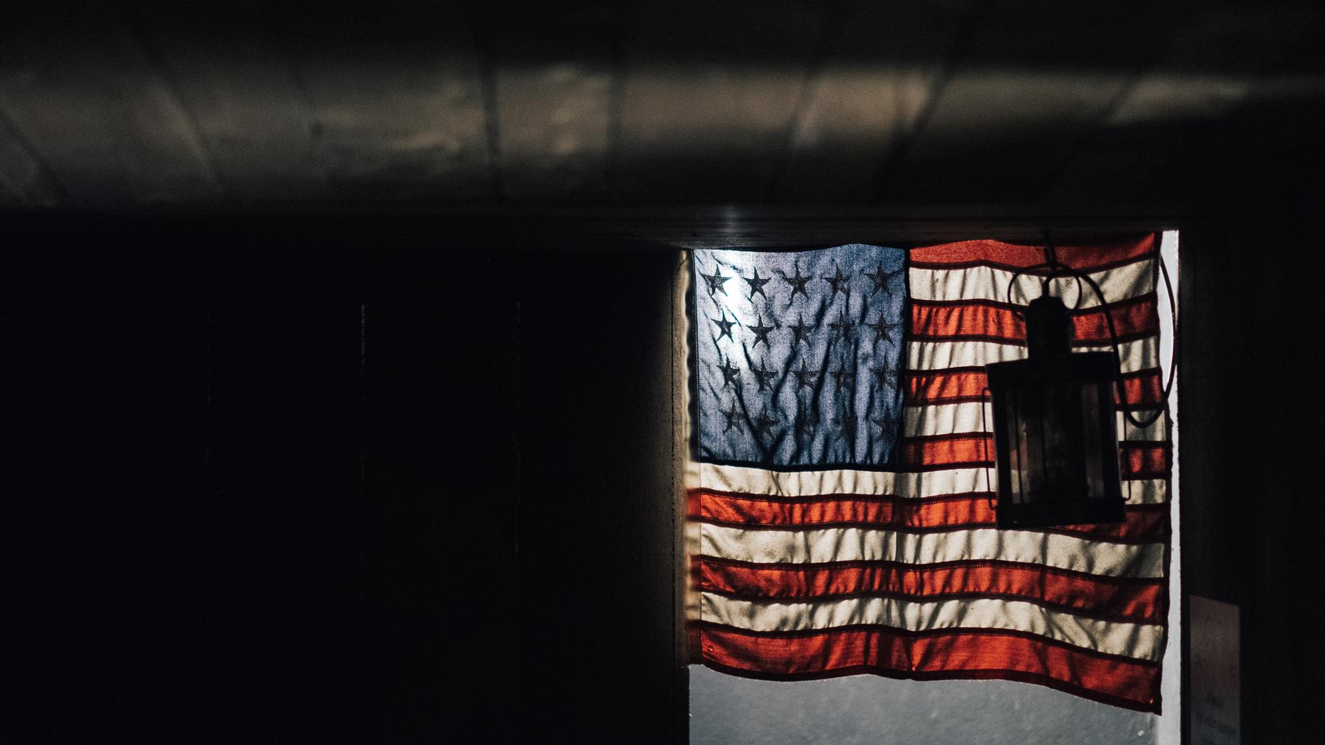 American Flag against a dark wall