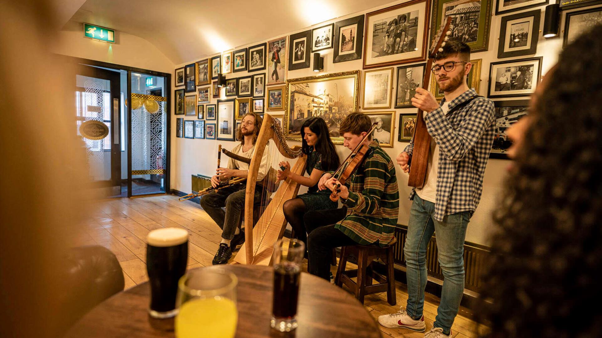 Musicians playing at Maddens Bar during the Belfast Story experience.
