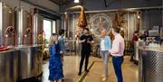 Tour group admire the stills within the Copeland Distillery