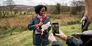 Visitors take photos with the little lambs during their visit to Dunfin Sheep Farm