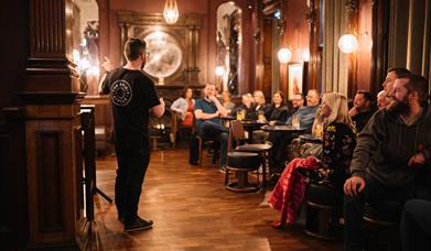 The Spirit Circle host welcoming a room full of guests to Belfast By The Glass Experience