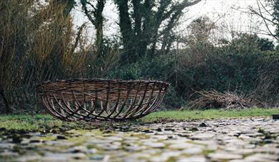 a wicker basket on the ground at ulster folk museum 
