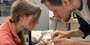 Man and Woman Making Wedding Rings Together