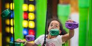Young girl on climbing wall
