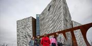 Tour group stands outside Titanic Belfast building