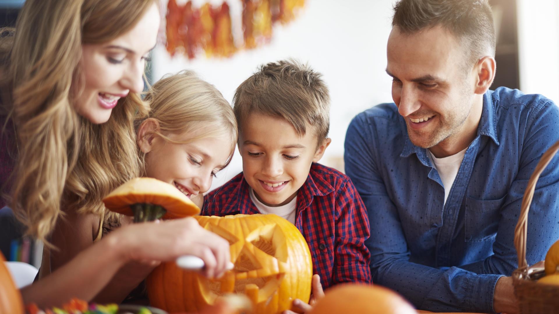 family carving a pumpkin family carving a pumpkin