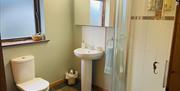Ensuite at Room with A View showing shower, sink, toilet, window & large light-up mirror.