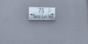 House number sign saying 73 Sea La Vie