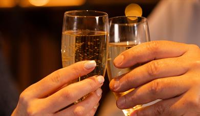 Promotional image for the 'Bed, Breakfast and Bubbly' offer showing two champagne glasses.