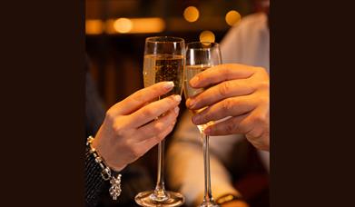 Promotional image for the 'Bed, Breakfast and Bubbly' offer showing two champagne glasses.