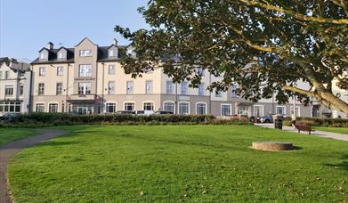 image of front exterior of the Portrush Atlantic Hotel  with garden and grounds to the forefront