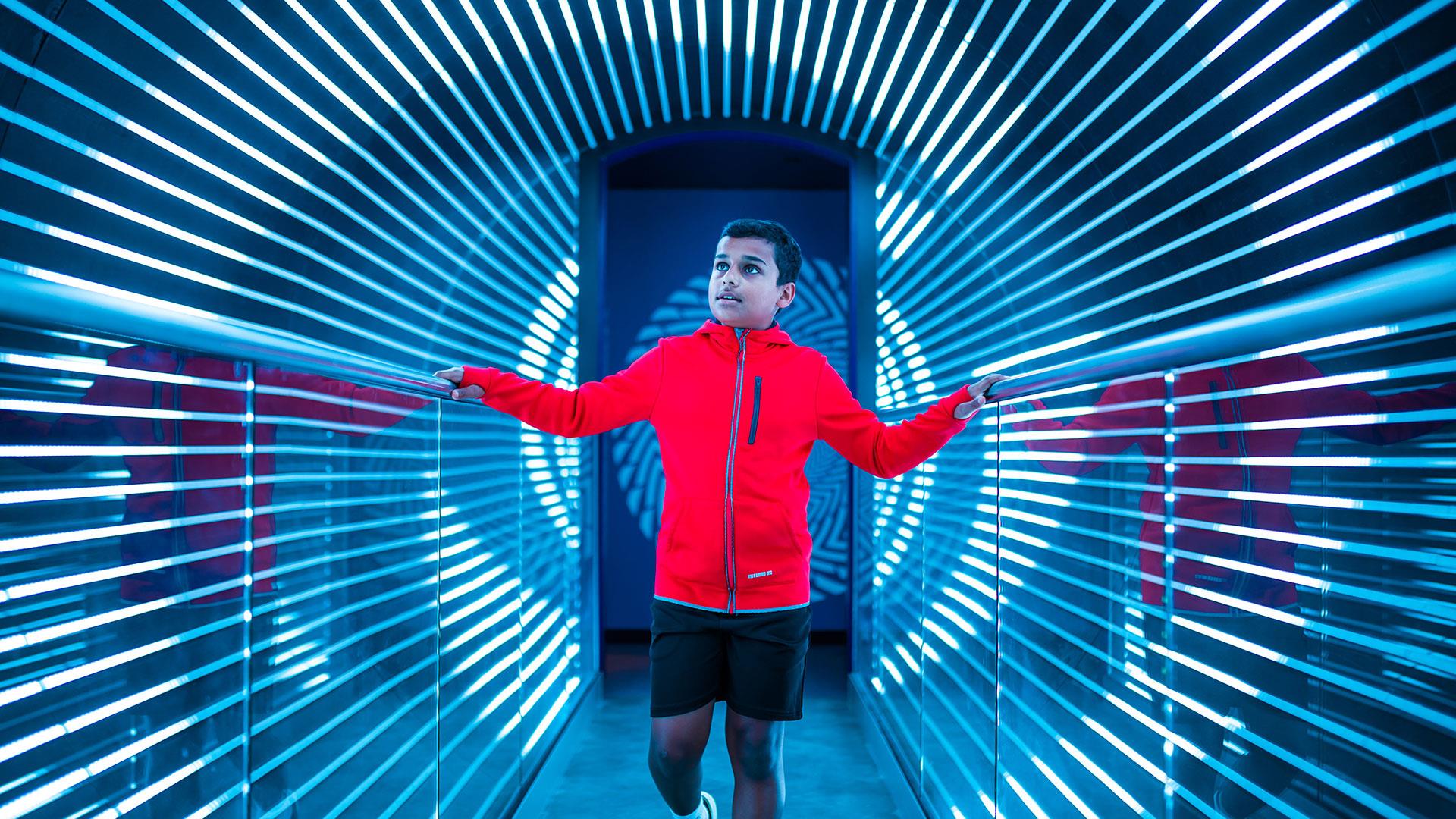 A mesmerising exhibition at W5 with a young boy walking through an optical illusion