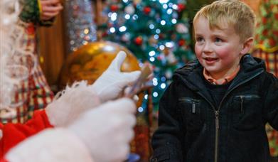Young boy with Father Christmas at ROARR!