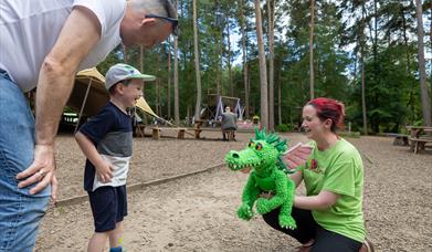 Child meeting puppet at bewilderwood