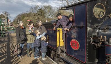A family speaks with the steam loco crew