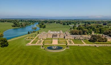 An aerial shot of the South Front of Holkham Hall on a beautiful sunny day.