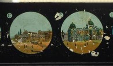 A amgic lantern slide with circles showing small paintings of buildings.