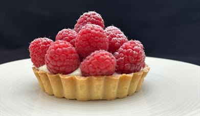Raspberry tart on a buttery crisp tart case