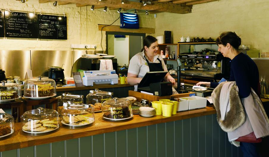 A customer and member of staff in the Muddy Boots café at Blickling Estate, Norfolk