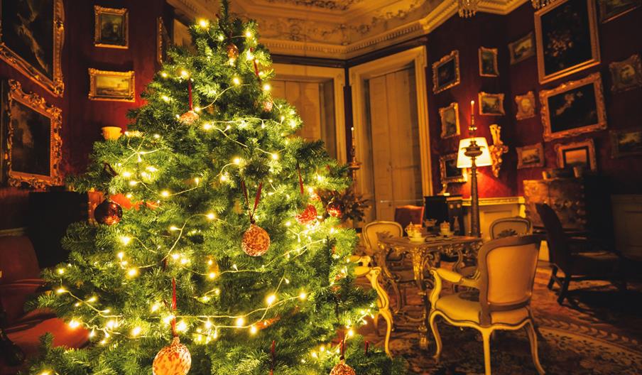 Opulent red Cabinet Room at Felbrigg Hall decorated for Christmas