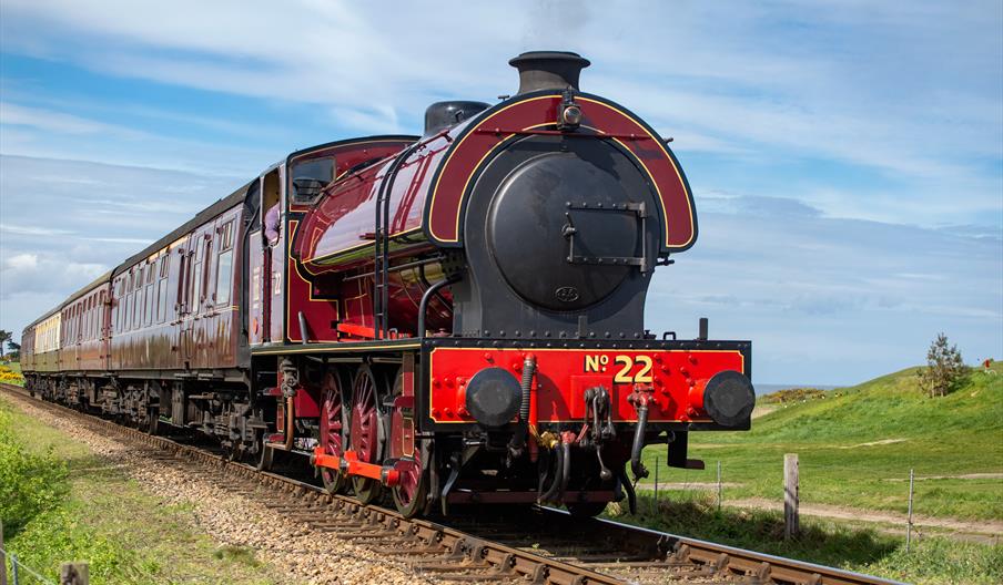 Steam locomotive passes Sheringham Golf Course