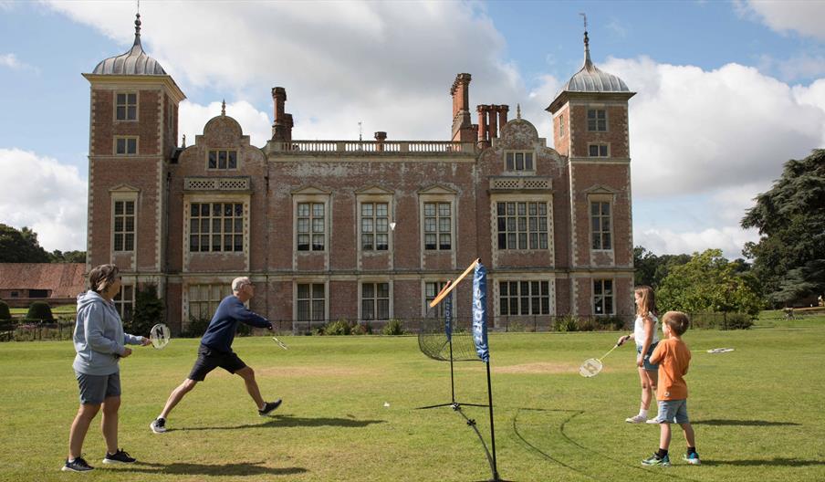 Family of four play a game of badminton at Blickling Estate