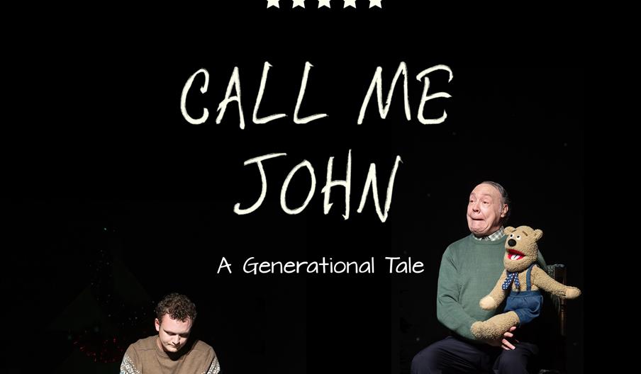 A grandfather and grandson sit apart on a black background. The grandson is reading a book, the grandfather is playing with a puppet.