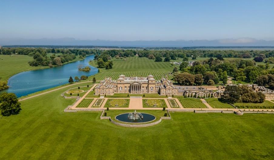 An aerial shot of the South Front of Holkham Hall on a beautiful sunny day.
