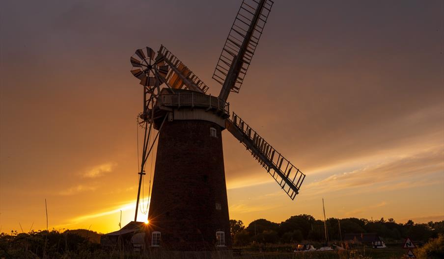 Sunset behind Horsey Windpump with the mill and reeds silhouetted